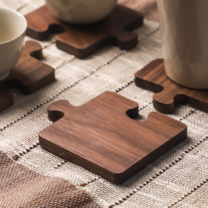 Interlocking walnut wood coasters stacked
